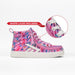 A pink high-top sneaker with a colorful abstract graffiti-style print, featuring a white sole and white laces. An inset circle highlights the white laces, and a red banner says 'WHITE LACES INCLUDED'.
