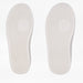 Two white shoe insoles shown side by side on a light background showing width differences. Both insoles have a textured tread pattern and a circular goat-head logo near the center.